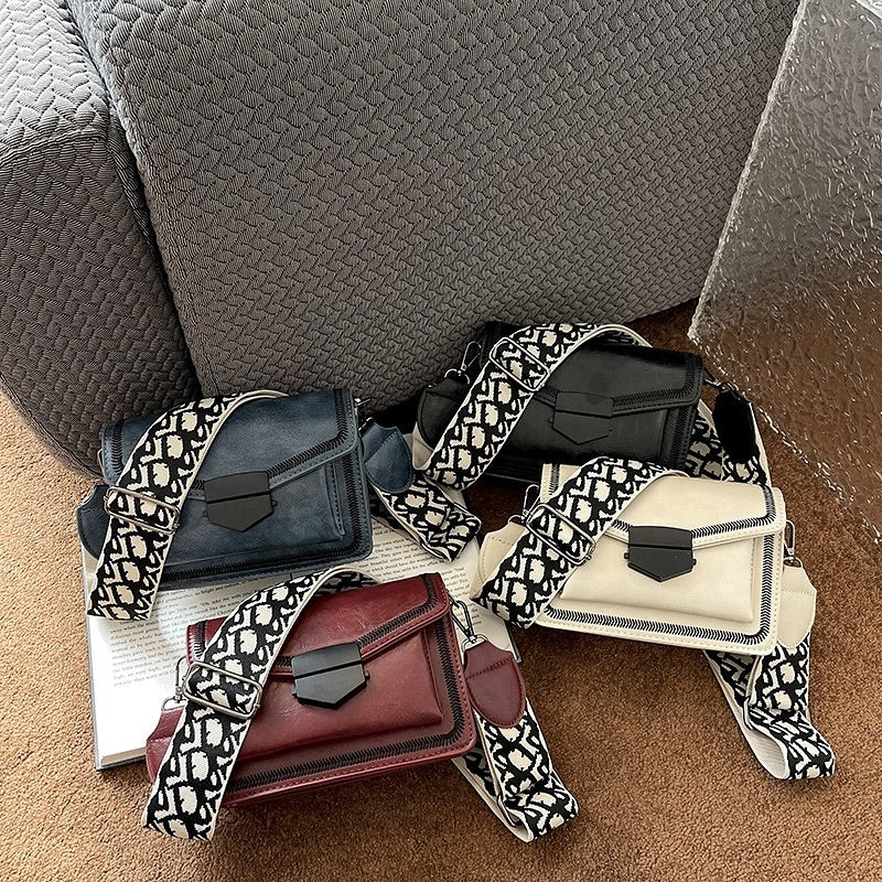 Timeless Leather Crossbody Bag with Decorative Strap