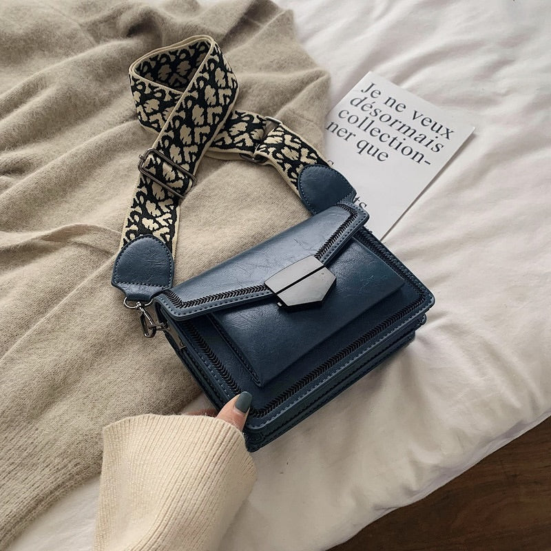 Timeless Leather Crossbody Bag with Decorative Strap