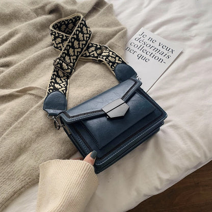 Timeless Leather Crossbody Bag with Decorative Strap