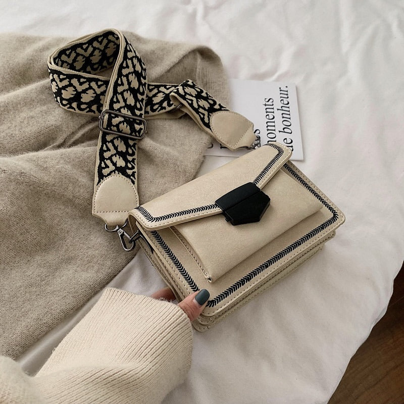 Timeless Leather Crossbody Bag with Decorative Strap