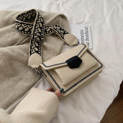 Timeless Leather Crossbody Bag with Decorative Strap