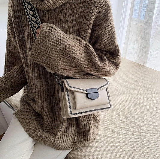 Timeless Leather Crossbody Bag with Decorative Strap