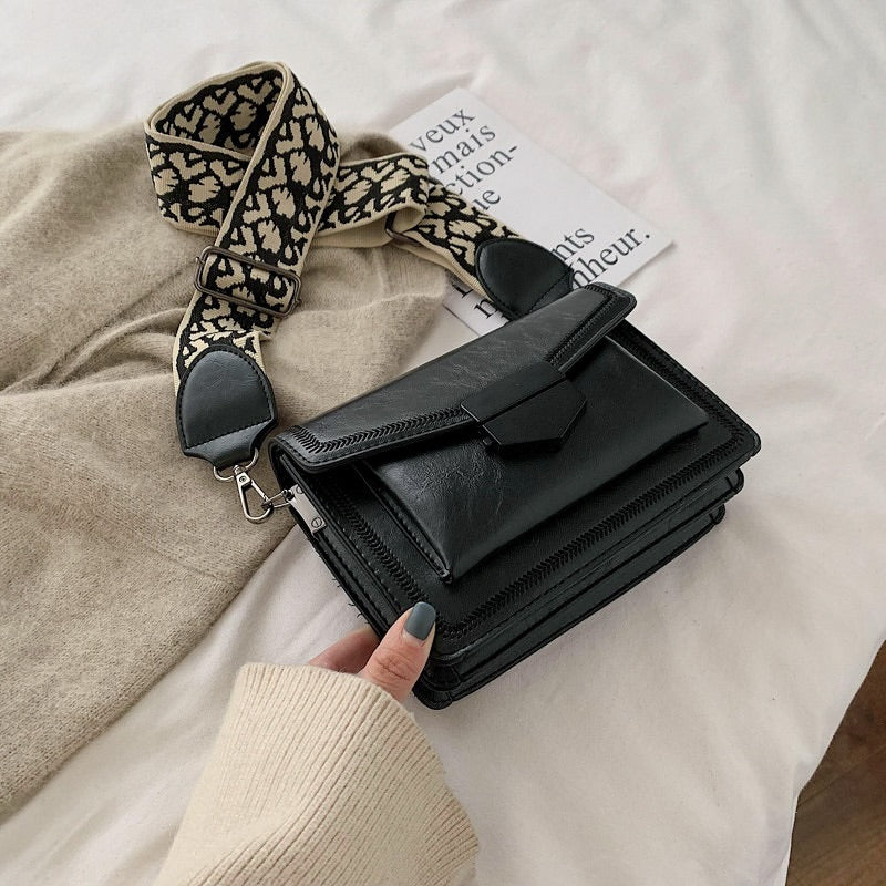 Timeless Leather Crossbody Bag with Decorative Strap