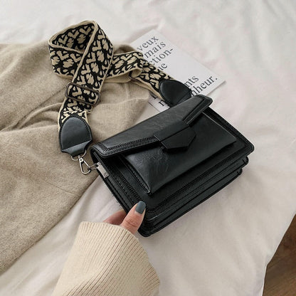Timeless Leather Crossbody Bag with Decorative Strap