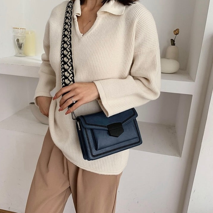 Timeless Leather Crossbody Bag with Decorative Strap